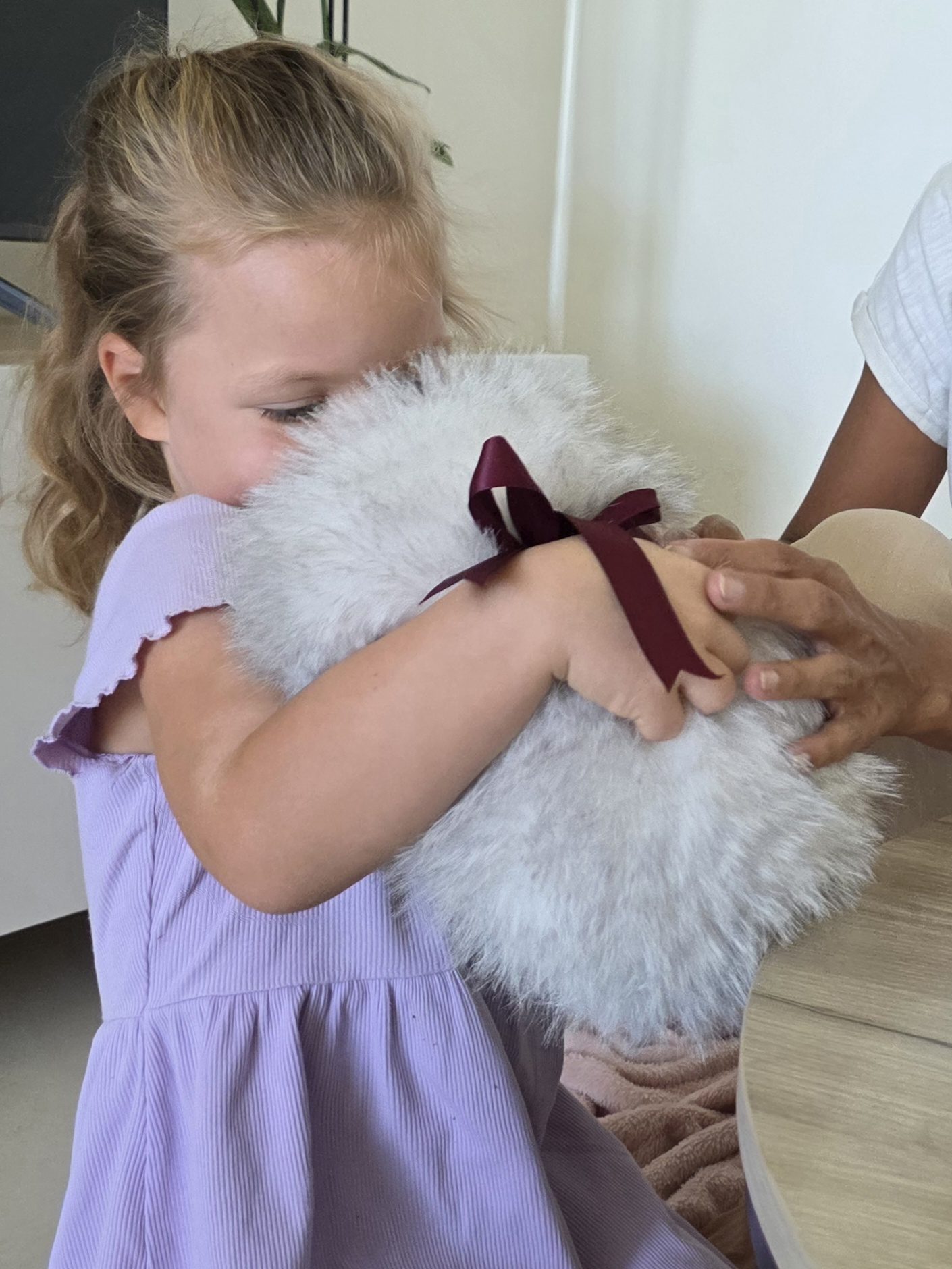 A child hugs Cupboo close to them